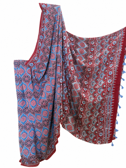Indigo and maroon Ajrakh hand block print Modal silk saree featuring geometric motifs, intricate traditional patterns and a decorative border with blue tassels