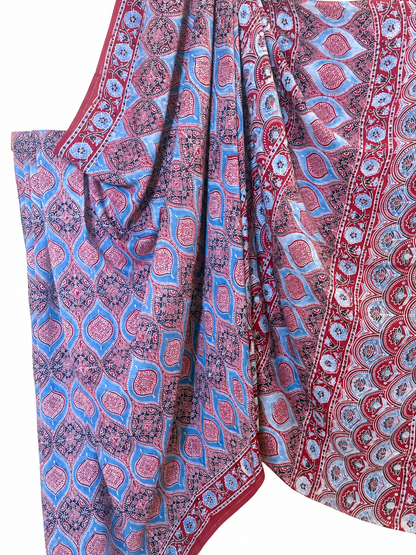 Close-up of indigo and maroon Ajrakh hand block print Modal silk saree featuring intricate paisley motifs, floral patterns and a traditional red decorative border